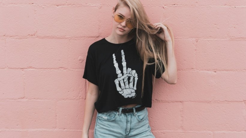 woman standing near pink concrete wall during daytime